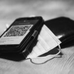Teléfono móvil mostrando un código QR junto a una billetera
